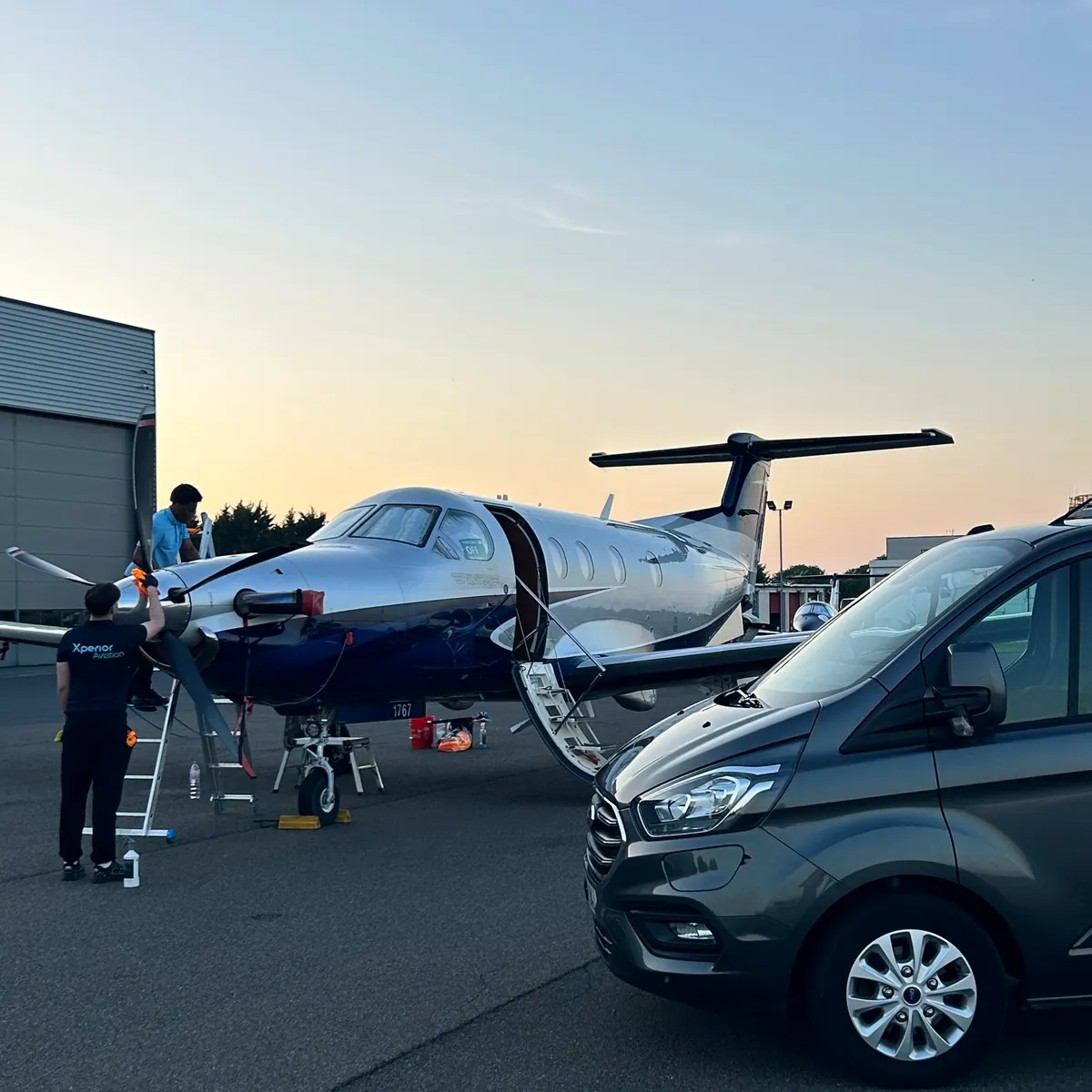 Xperior Aviation crew carrying out an exterior valet on a private turboprop at dusk