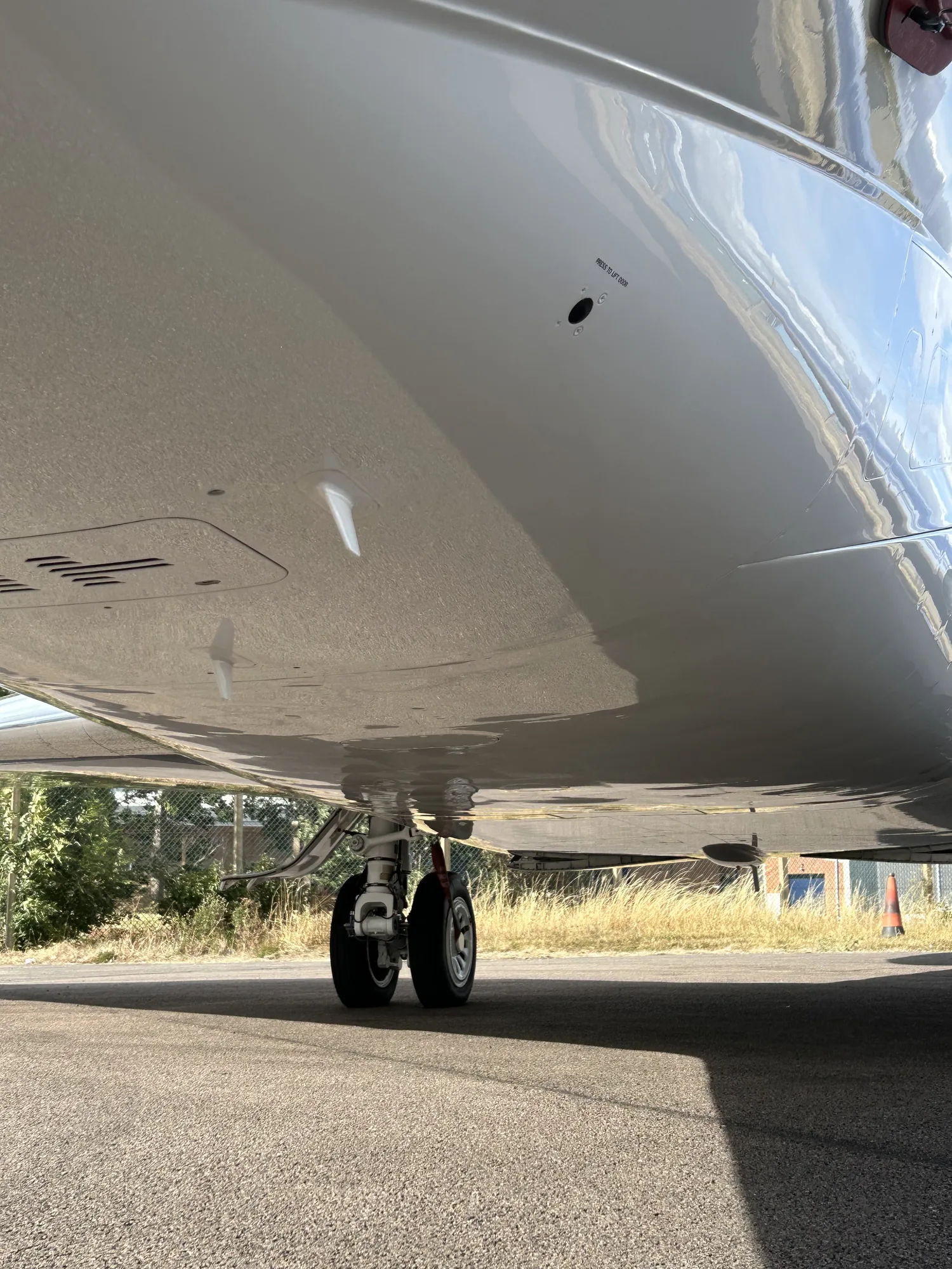 Private jet belly and main landing gear after a full exterior clean and degrease