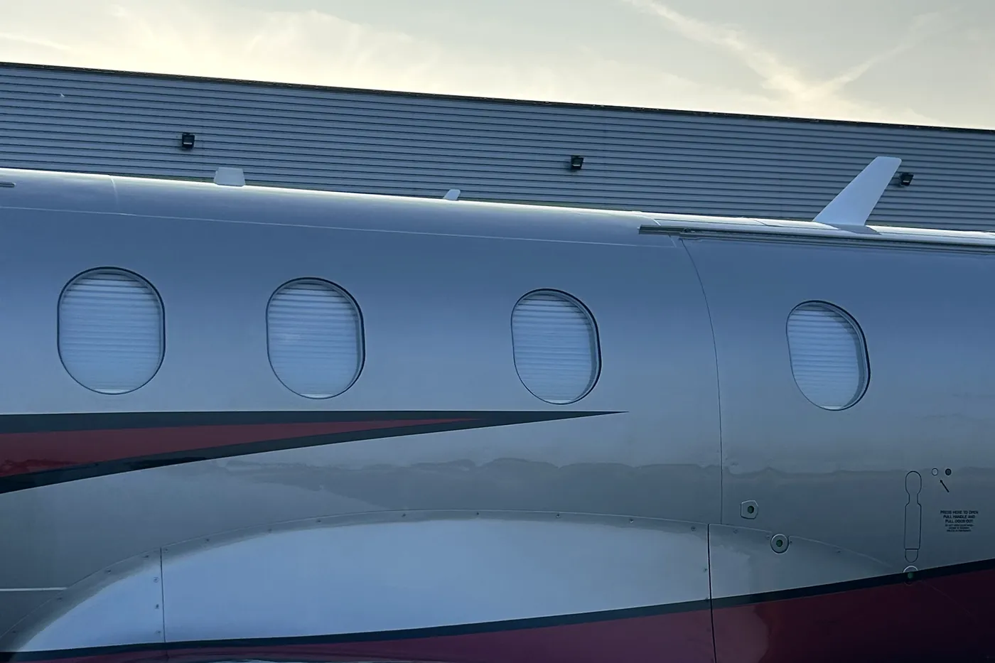 Polished fuselage and cabin windows on a private jet after exterior detailing