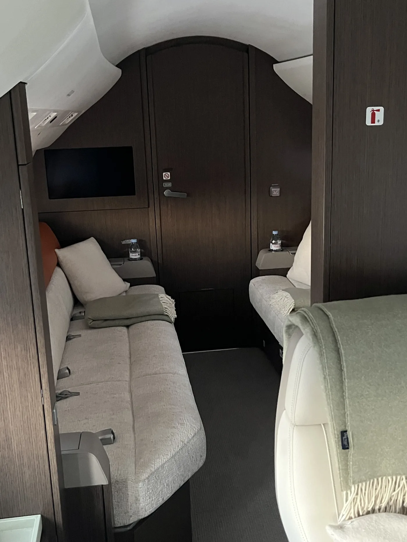 Private jet cabin divan and wood cabinetry after interior valeting